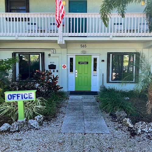 A building with an American flag, green door, 